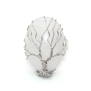 Silver wire wrapped Tree of Life ring featuring an oval white natural crystal stone