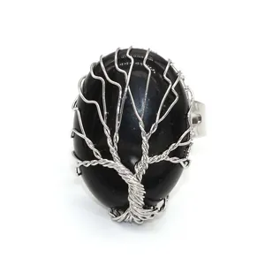 Detailed view of handmade silver wire-wrapped tree of life ring with black oval stone