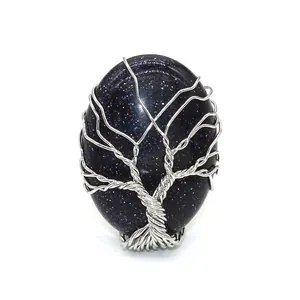 Silver wire-wrapped tree of life ring featuring an oval blue sandstone gemstone detail
