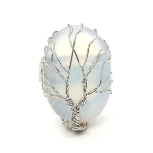 Detailed view of handmade Tree of Life wire wrapped ring with oval white stone
