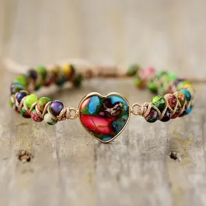 Vue détaillée d'un bracelet tissé main avec des perles en pierre d'empereur et un pendentif cœur