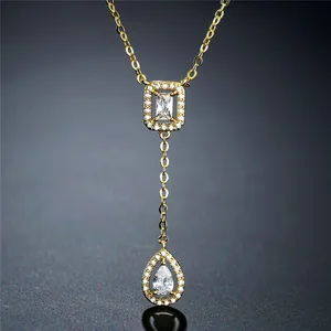 Close-up of gold Y-shaped necklace with elegant waterdrop and rectangle zircon pendants