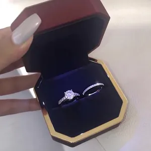 Detailed view of silver zircon ring set presented in a red hexagonal jewelry box