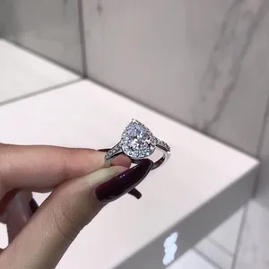 Close-up of exquisite pear-shaped halo engagement ring with sparkling stones detail