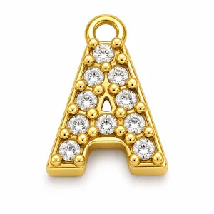 Detailed macro view of a gold-plated stainless steel letter A pendant with sparkling crystals.