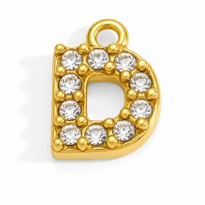 Detail of gold-plated stainless steel letter D pendant with sparkling rhinestones