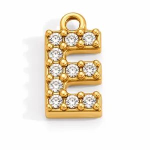 Detailed view of a gold plated stainless steel letter E pendant with cubic zirconia inlay