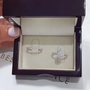 Elegant pear-shaped halo engagement ring set in a luxury box with a pave wedding band.
