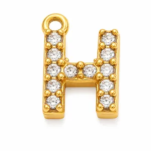 Detail of a gold-plated stainless steel letter H pendant with pavé cubic zirconia.