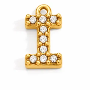 Macro view of a luxury gold-plated stainless steel letter I charm with clear zircons