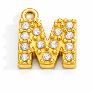 Detailed view of a gold-plated stainless steel letter M pendant with clear crystals
