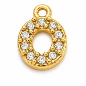 Macro detail of gold-plated stainless steel letter O charm with clear rhinestones