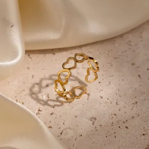 Close-up of elegant gold stainless steel ring with continuous openwork heart design