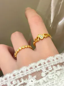 Primo piano dell'anello d'oro traforato e della fascia di perline con strass