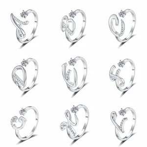 Detail view of nine adjustable silver-tone rings featuring pavé-set letters from A to I