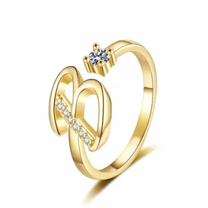 Detailed view of gold letter B ring featuring sparkling cubic zirconia stone accents.