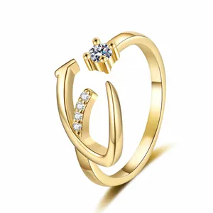 Detailed close-up of a gold-plated letter V ring featuring brilliant cubic zirconia