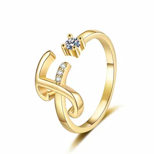 Detailed view of gold-tone letter H ring with sparkling cubic zirconia accents and polished finish