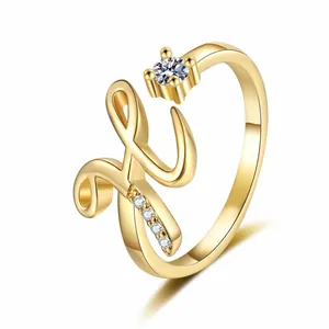 Professional detail shot of a gold-plated letter H open ring with sparkling zircon inlays.