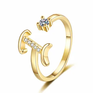 Detailed view of a gold-plated letter open ring with sparkling zirconia stones.