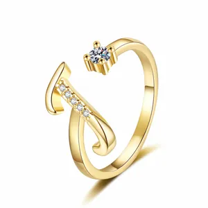 Detail showing the 'J' initial and sparkling zircon stones on this gold adjustable ring