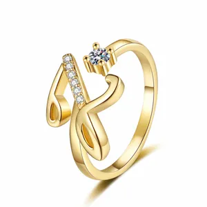 Close-up detail of golden letter 'N' ring with sparkling cubic zirconia accents