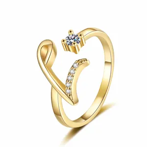 Detailed close-up view of a gold-plated letter V initial ring with sparkling zircon stones