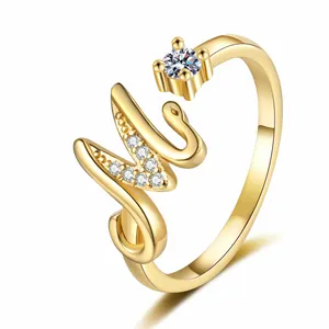 Detailed close-up of a gold initial M ring featuring sparkling zircon stones decoration