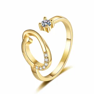 Macro view of a gold-plated letter J ring meticulously set with sparkling zircon stones