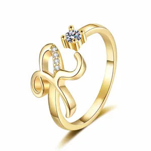 Detailed view of a gold-plated letter R ring with sparkling cubic zirconia accents.