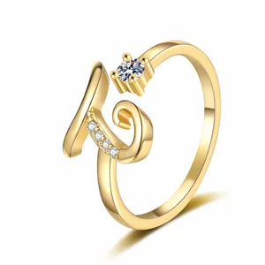 Detailed view of the gold-tone letter G ring encrusted with brilliant zircon stones.