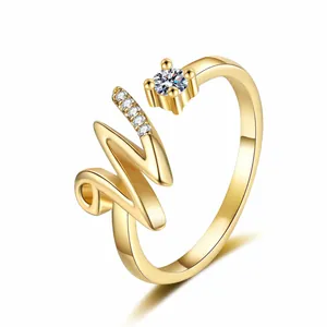 Detailed view of the gold-tone letter M open ring featuring sparkling pavé zircons.