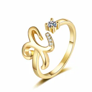 Detailed view of a gold-plated open ring featuring a sparkling zircon and letter design