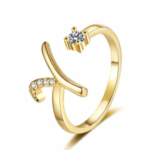 High-definition macro detail of the elegant gold letter R ring featuring sparkling zircon stones.