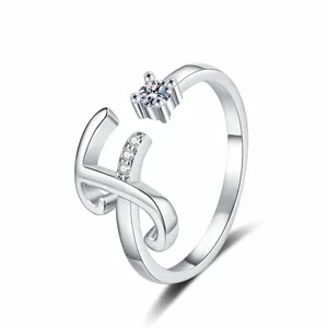 Exquisite detail view of silver letter H ring with sparkling cubic zirconia stones