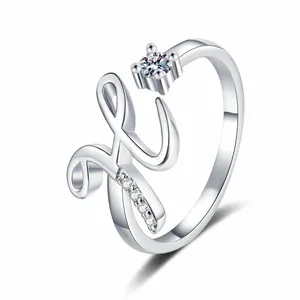 Close-up view of a silver-toned adjustable ring featuring a cursive letter H and zircon