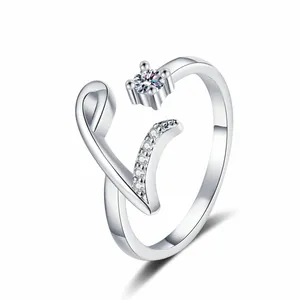 Close-up of an elegant silver-tone open ring featuring a sparkling zircon and letter V