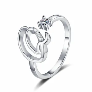 Detailed view of a silver-toned adjustable ring with letter design and sparkling zircons