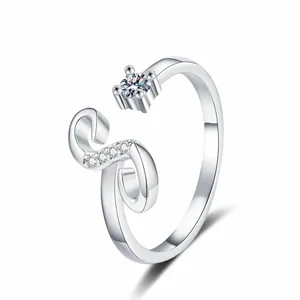 Detailed view of an elegant silver-tone open ring with sparkling zircon letter design