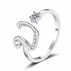 Detailed view of silver letter V ring with sparkling cubic zirconia stones