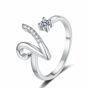 Macro view of a silver-toned open ring with sparkling letter V and round zircon