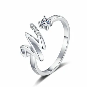 Macro detail of silver adjustable ring featuring a diamond-encrusted artistic letter W