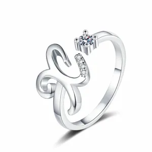 Detailed view of an adjustable silver ring with a stylized letter K and zircon accents