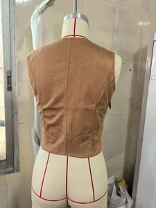 Detail view showing the back profile of a brown faux suede western style vest on mannequin