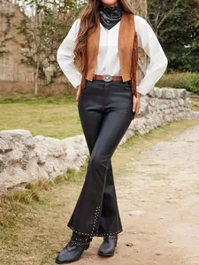 Brown western faux suede fringe vest for women in hippie cowgirl style outdoors