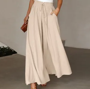 Detailed view of high-waisted wide-leg trousers with elastic waistband and drawstring.