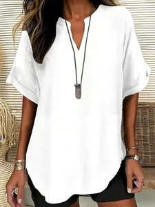 Detailed view of white V-neck women's blouse featuring breathable textured fabric.