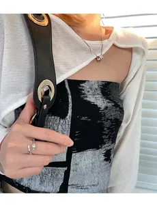 Vintage silver snake ring and cylinder pendant necklace shown on a model
