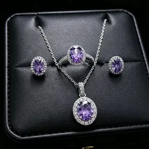 High quality macro detail of purple oval gemstone jewelry set presented in a black leather box