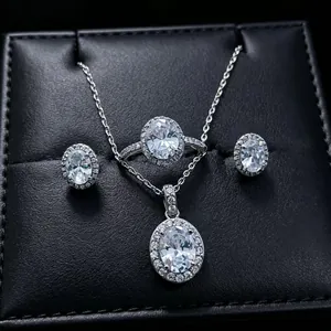 Close-up of oval halo moissanite jewelry set including necklace, ring, and earrings